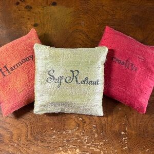 3 small pillow sachets with 'Self Reliant' ‘Creative’ and ‘Harmony’ Text.